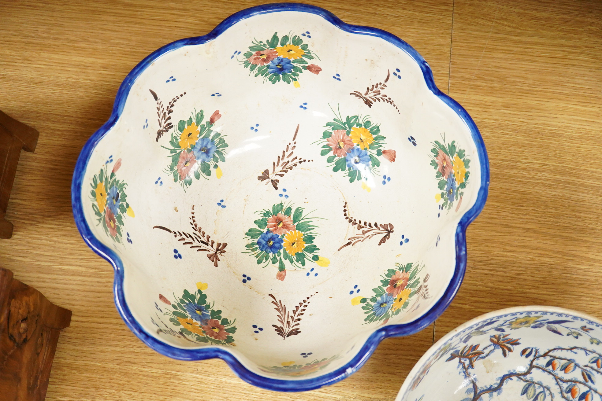 An Italian faience punch bowl painted with flowers and masks and an ironstone pedestal bowl, largest 31cm in diameter